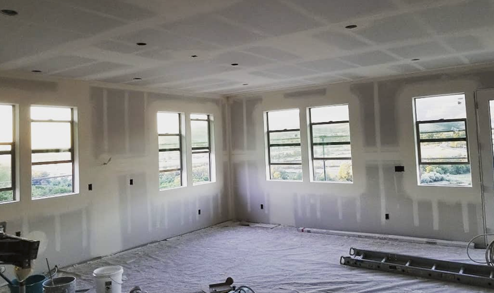 Great room hung and taped with windows overlooking the valley