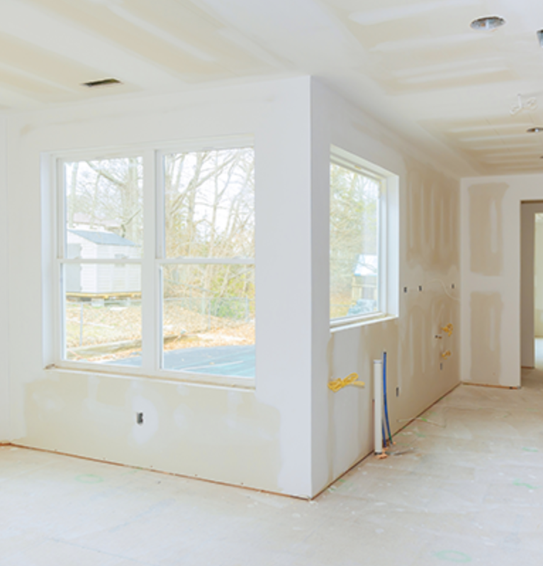 Residential interior with hung and taped walls around new windows